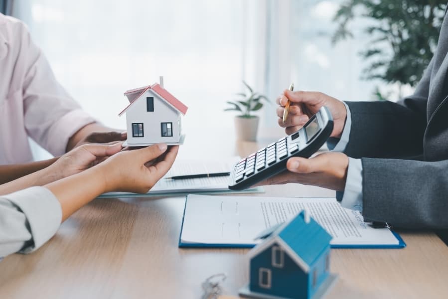 Mortgage advisor walking a first-time buyer through their options at a desk