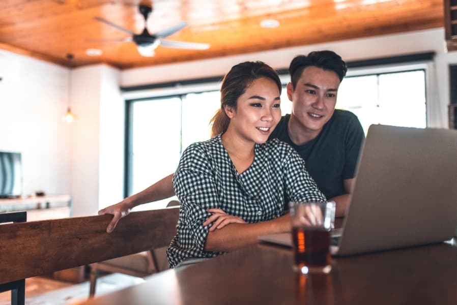Couple reviewing their Home Buyers' Plan withdrawal on a laptop
