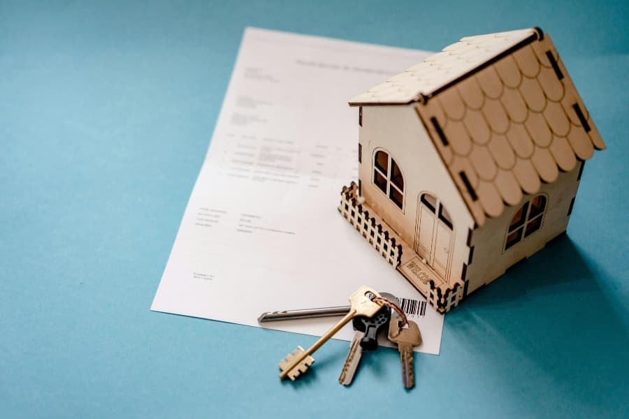 House keys resting on a signed mortgage document