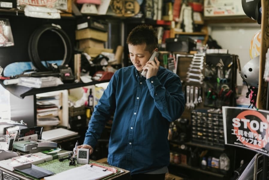 Self-employed business owner reviewing paperwork at work
